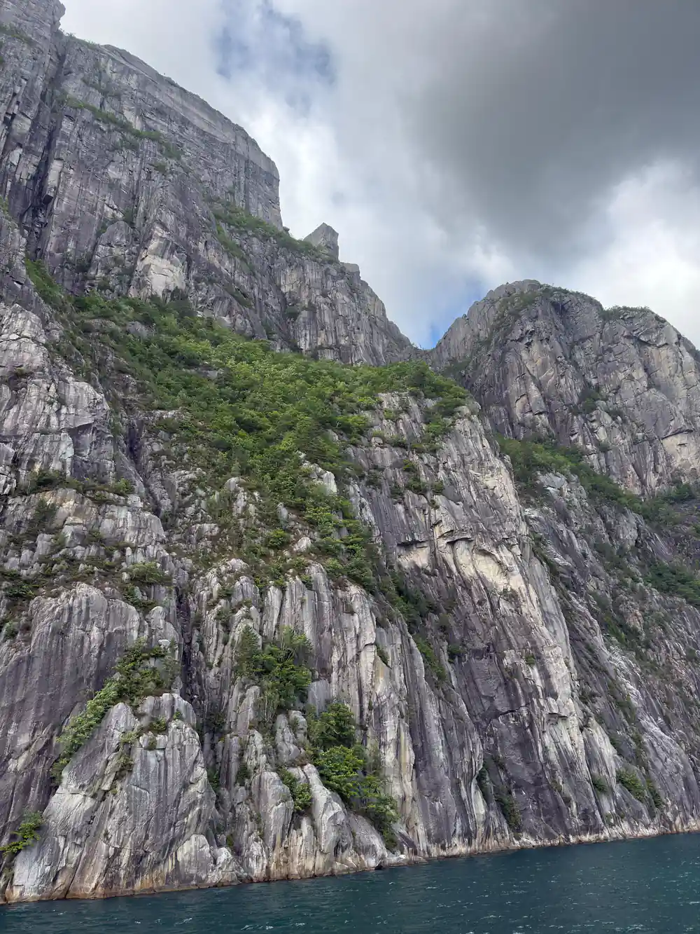 Columnar basalt cliffs rising from fjord water
