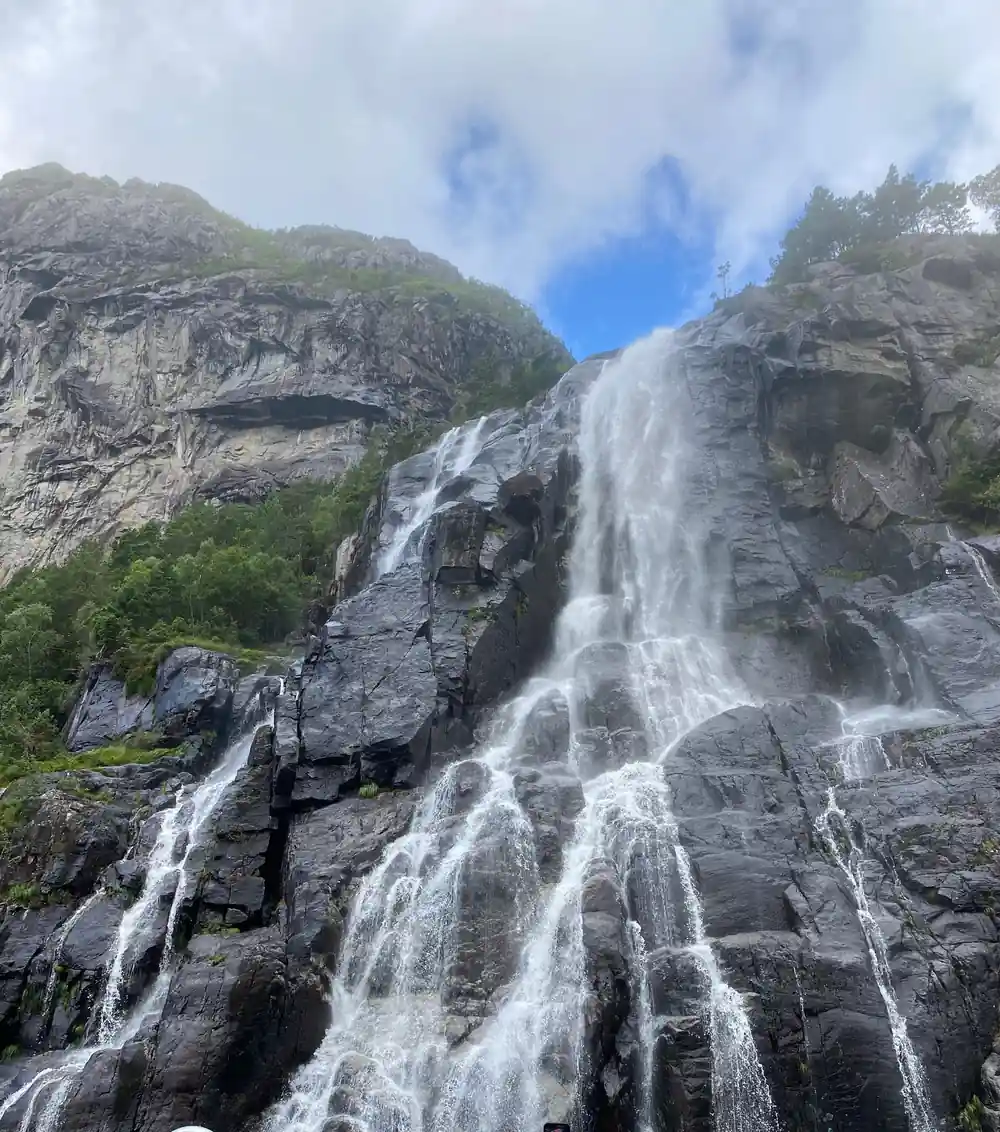 Multiple waterfalls cascading down rocky mountainside