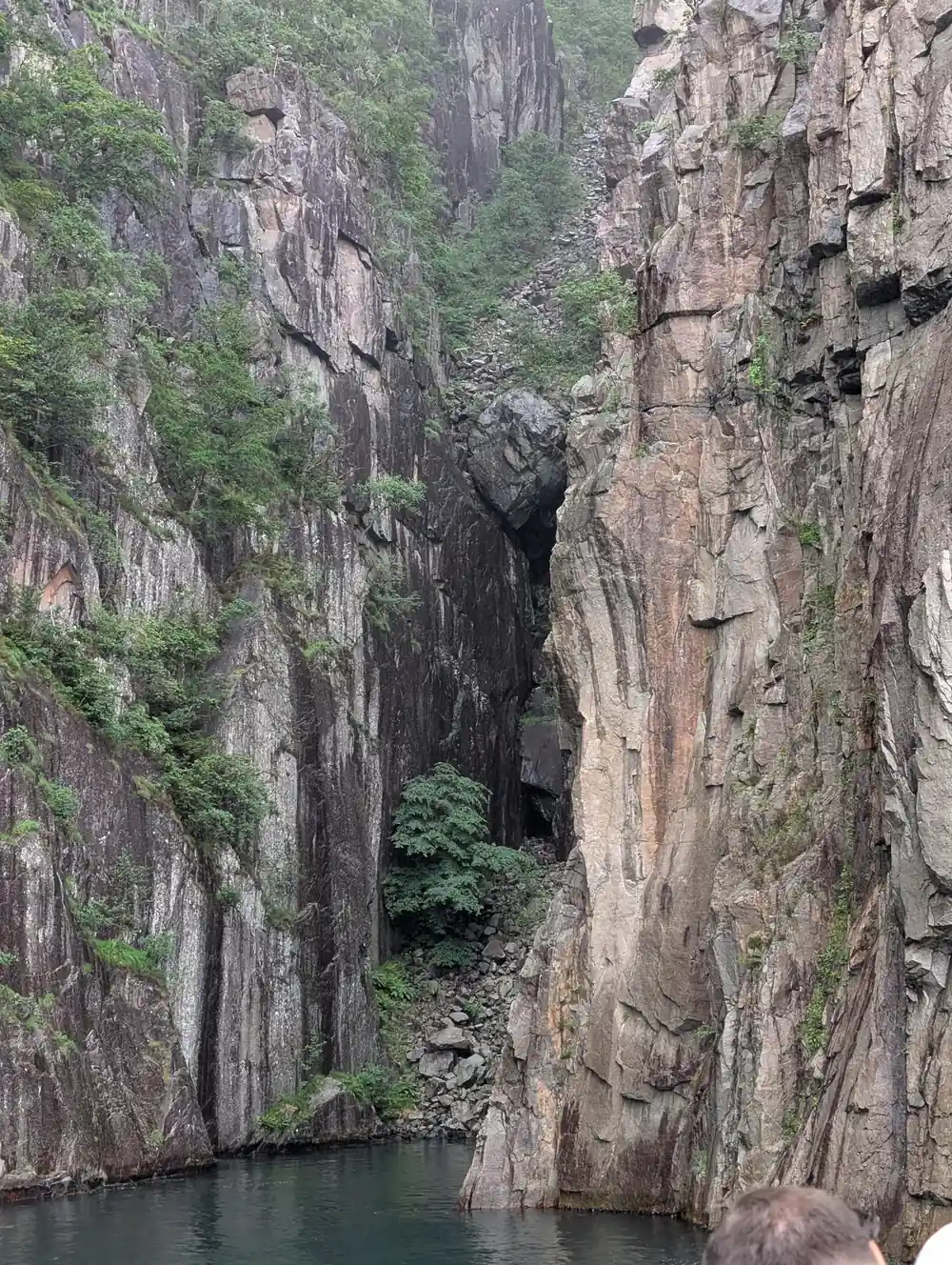 Narrow cave passage between tall vertical rock walls