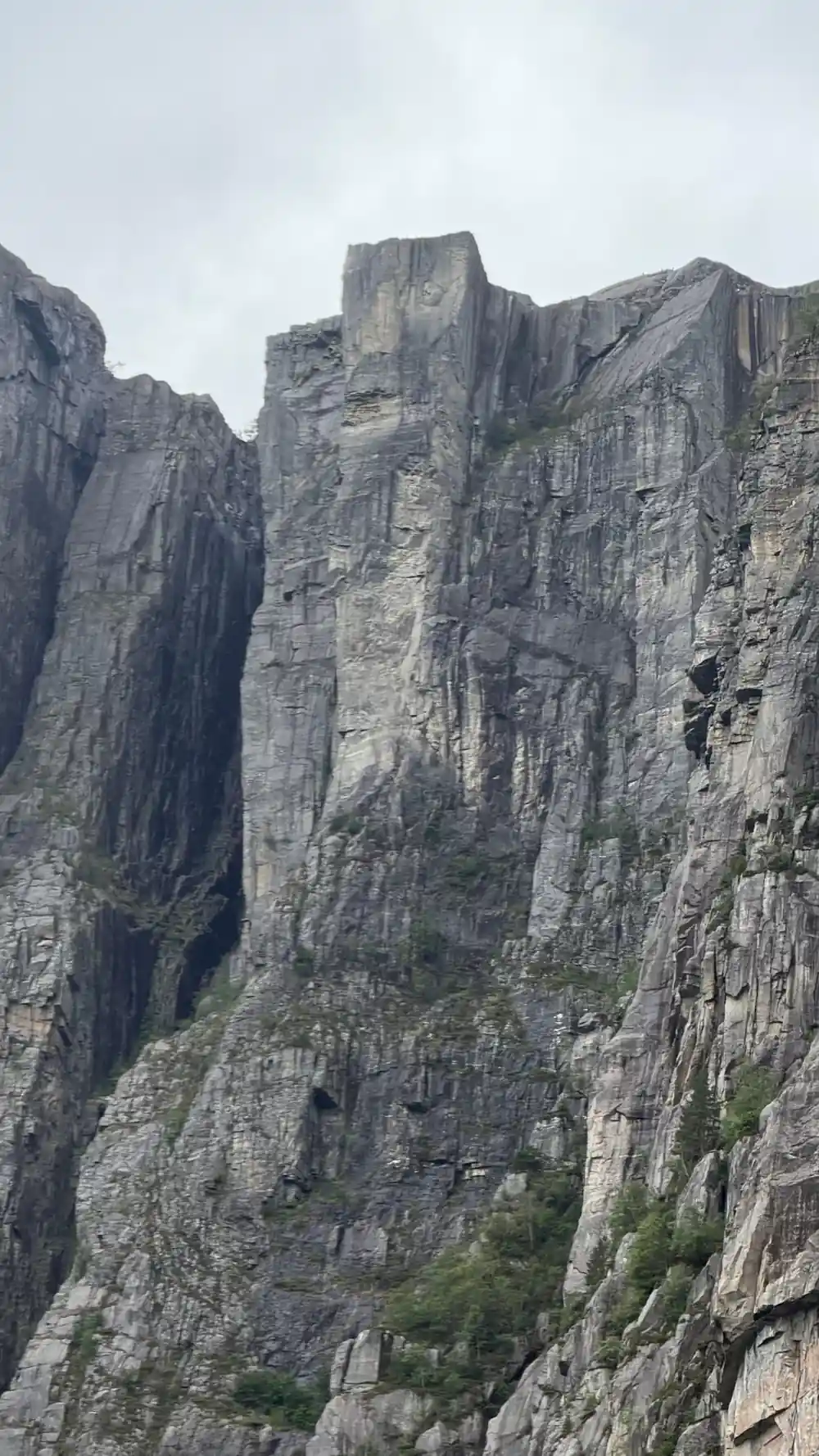 Tall columnar basalt rock formation rising from valley